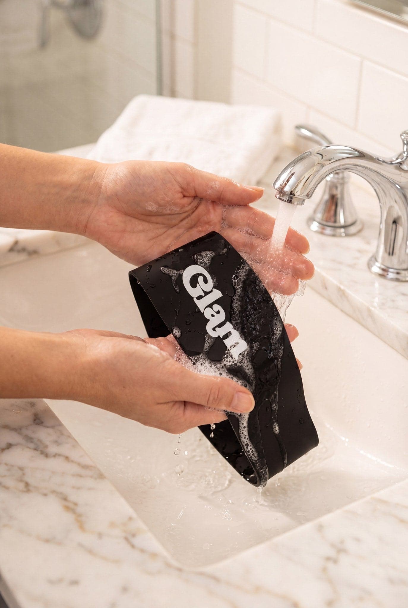 Rinsing the face at the sink while the band keeps edges dry